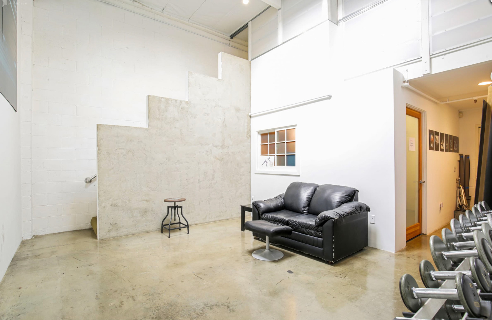 Green Room with Couch and workout weight equipment